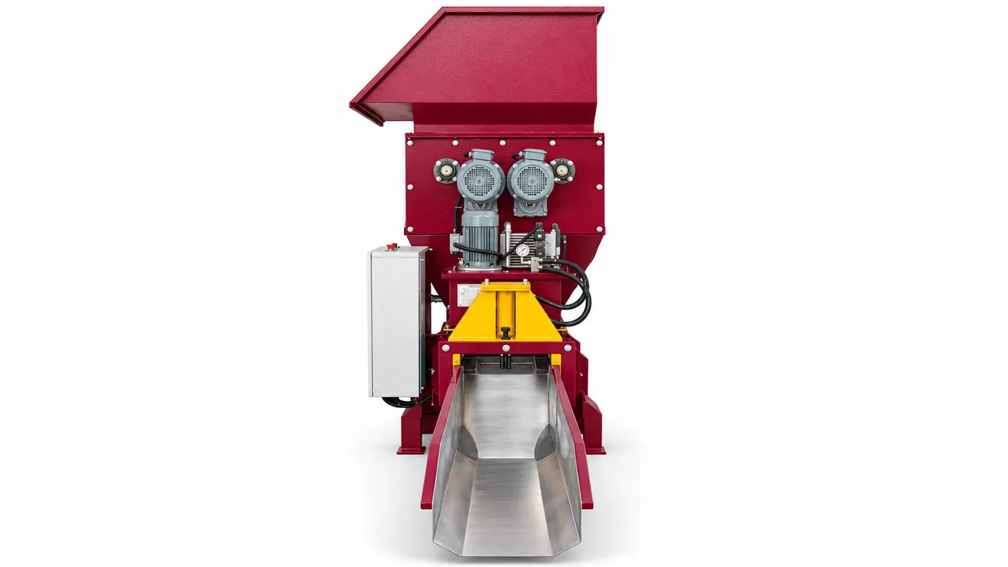 Discharge-end view of the EPS cold press machine showing the outlet and block collection channel