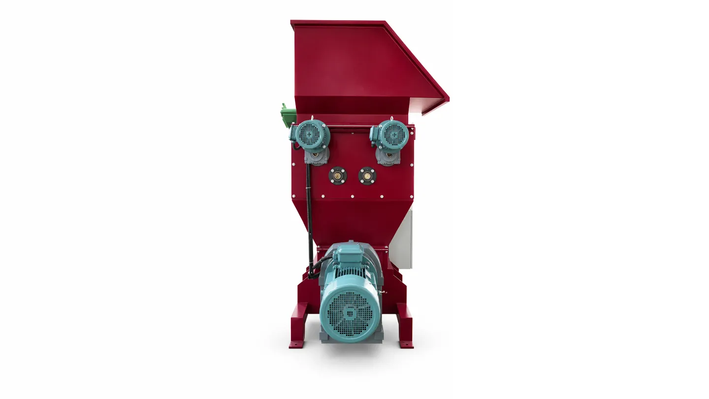 Drive-end view of the EPS cold press machine showing the crusher motors and main screw drive